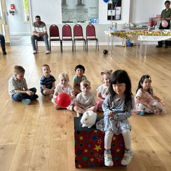 Children laughing and clapping along to Magic Stuart’s exciting magic show in Allestree.