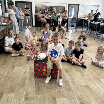 Smiling children watching a magical performance at a family event in Allestree.