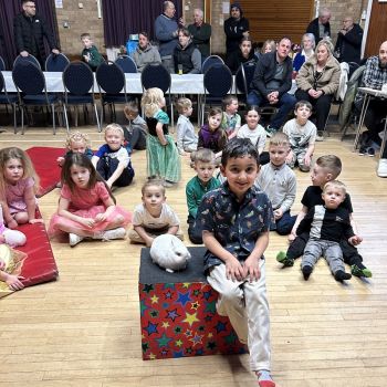 Magic Stuart performing an interactive magic show for children at a birthday party in Arnold.