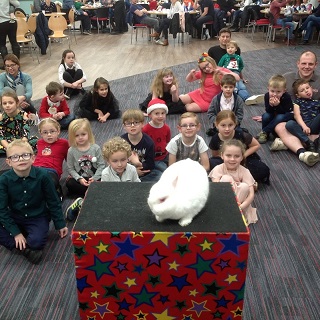 Magic Stuart performing a festive magic show for children at a Christmas party in Derby