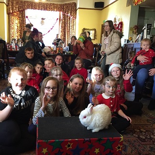 Children enjoying a Christmas-themed magic show by Magic Stuart in Derby