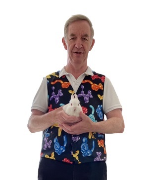Image of magician Magic Stuart standing with Snowy the rabbit.