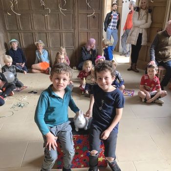 Children clap and cheer during a lively magic show in Nottingham.