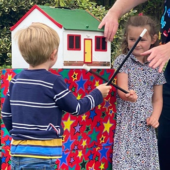 Making the birthday boy or girl the star of the show with hands-on magic performance.