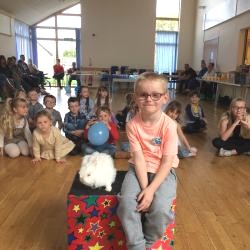 Snowy the live white rabbit meeting happy children at a Bretby party venue