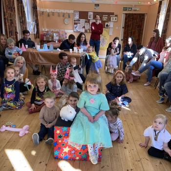 A group of children laughing and clapping during a birthday party show in Hucknall