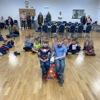 A group of children laughing and clapping during a birthday party show in Stoke On Trent