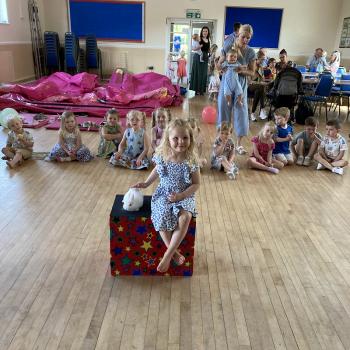 A group of children laughing and clapping during a birthday party show in Sutton In Ashfield