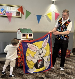 Excited children enjoying Magic Stuart's high-energy entertainment at a party in Derby with smiles and laughter throughout