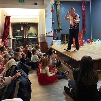 Capturing genuine smiles and amazement from children during an interactive magic performance.
