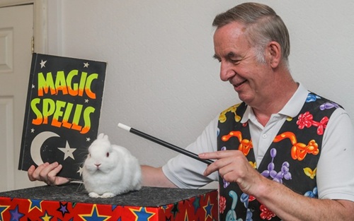 Press image showing Magic Stuart with his rabbit Snowy at a children’s event.
