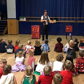 Children's entertainer performing an interactive fun magic show at a christmas party in Arnold