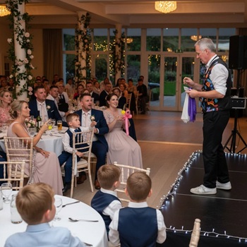 Children's entertainer performing an interactive fun magic show at a wedding in Carlton