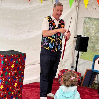 Children's entertainer performing an interactive fun magic show at a birthday party in Nottingham