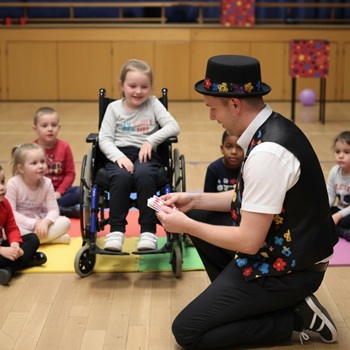 Children's entertainer performing an interactive fun magic show at a birthday party in Swadlincote