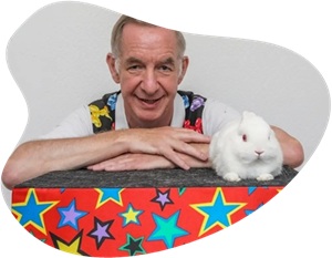 Magician performing a fun magic show for children’s birthday party in Derby with live rabbit Snowy.