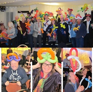 Magic Stuart leading a creative balloon modelling workshop encouraging teamwork and imagination.