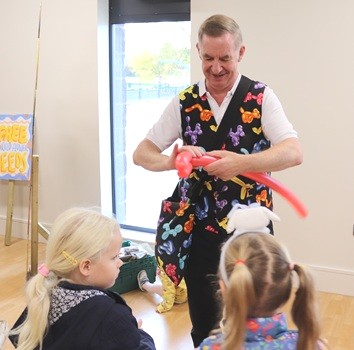 Magic Stuart balloon modelling at indoor party event Magic Stuart making balloon animals for children at an indoor family party in Derbyshire