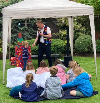 Parents enjoying stress-free birthday party while Magic Stuart provides complete entertainment for children in Derby