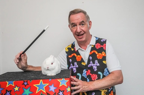 Still image of Magic Stuart and Snowy during a TV interview about children’s parties.