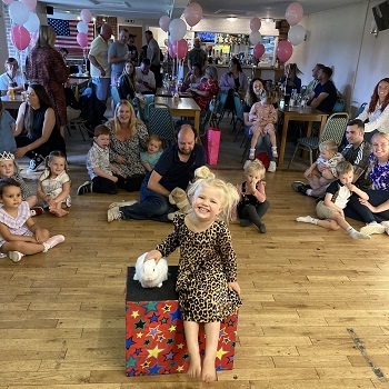 childrens party entertainer magician magic show Magic Stuart captivating children with a magic show at a Derby party