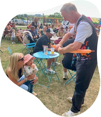Magic Stuart entertaining children with balloon modelling and magic tricks in Derbyshire